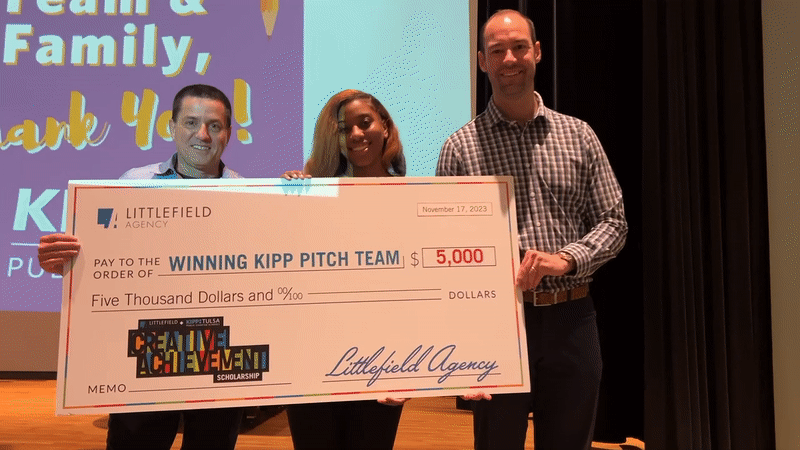 KIPP Tulsa and Littlefield Agency Host The Second Annual Pitch Competition. Mike Rocco, KIPP Student Winner, Sam Littlefield holding scholarship check.